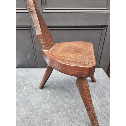 1064 - A carved oak spinning stool, by Jack Grimble, Cromer.