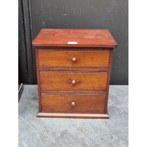 1097 - An unusual early 20th century miniature oak wardrobe, 44.5cm high x 37.5cm wide; together with ... 