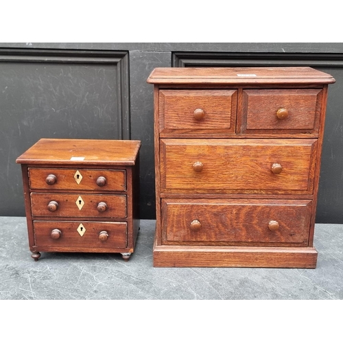 1098 - A miniature Victorian walnut three drawer chest, with bone escutcheons, 21.5cm high x 22cm wide... 