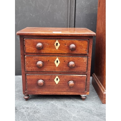 1098 - A miniature Victorian walnut three drawer chest, with bone escutcheons, 21.5cm high x 22cm wide... 