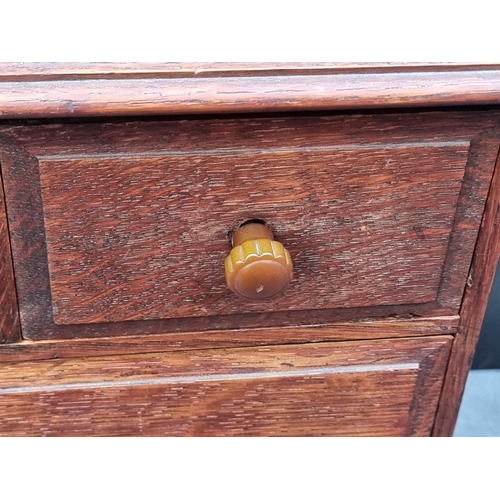 1098 - A miniature Victorian walnut three drawer chest, with bone escutcheons, 21.5cm high x 22cm wide... 