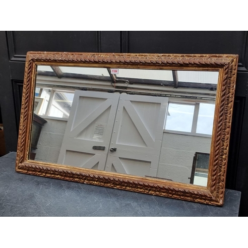 1104 - A gilt framed rectangular wall mirror, 57.5 x 94cm.