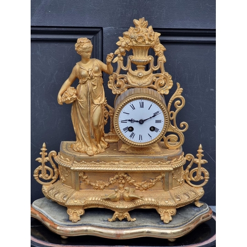 1111 - A Victorian gilt spelter mantle clock, 34cm high, on giltwood stand, with further ebonized stand and... 