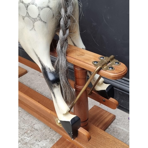 1716 - A dapple grey rocking horse, 135cm wide.  