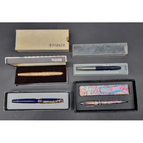 1676 - A Parker 61 gilt fountain pen, boxed with instructions; together with three other various pens.... 