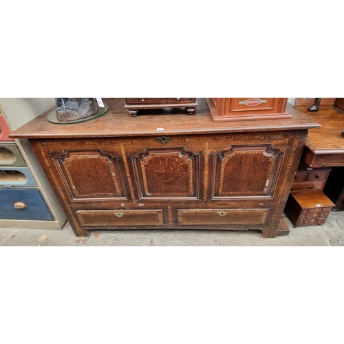 1001 - An 18th century oak and inlaid panelled mule chest, 147.5cm wide.