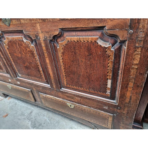 1001 - An 18th century oak and inlaid panelled mule chest, 147.5cm wide.