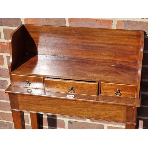 1054 - A small mahogany side table, incorporating three frieze drawers, 61cm wide.