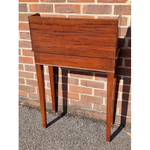 1054 - A small mahogany side table, incorporating three frieze drawers, 61cm wide.