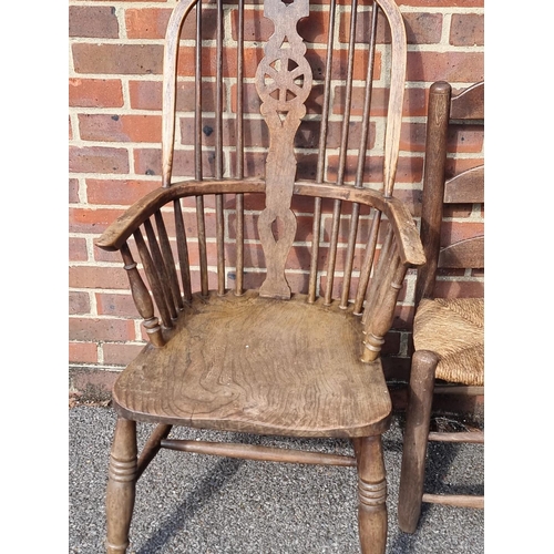 1065 - An antique beech lath back kitchen elbow chair; together with another ash, elm and beech wheelback W... 