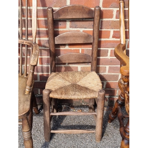 1065 - An antique beech lath back kitchen elbow chair; together with another ash, elm and beech wheelback W... 