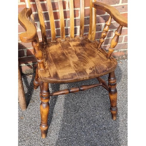 1065 - An antique beech lath back kitchen elbow chair; together with another ash, elm and beech wheelback W... 