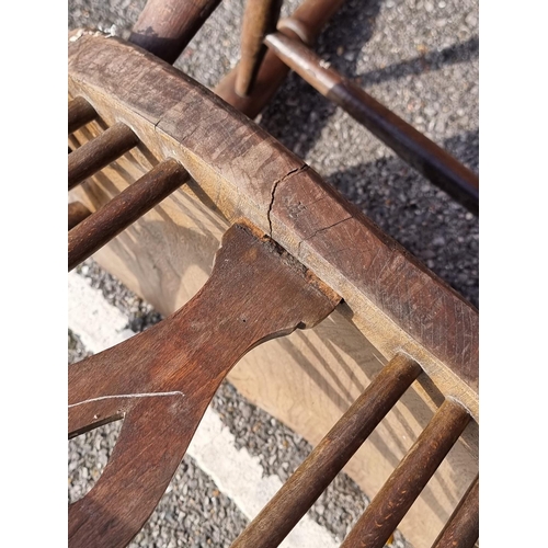 1065 - An antique beech lath back kitchen elbow chair; together with another ash, elm and beech wheelback W... 