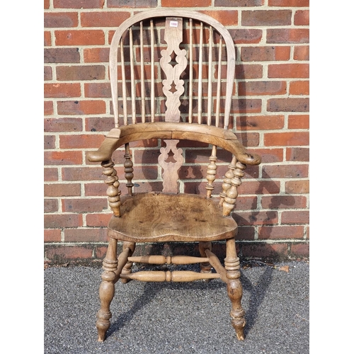 1066 - A Victorian ash and elm highback Windsor armchair.