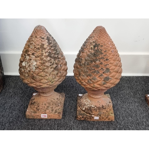 1768 - A pair of terracotta pinecone gate pier finials, 48cm high.