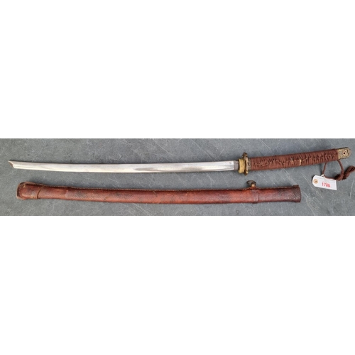 1788 - A reproduction Japanese katana and scabbard, having 69cm Damascus blade, overall length 103cm.... 