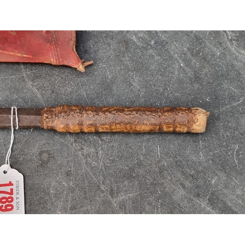 1789 - A West African Yoruba tribe Ida short sword, with 60cm double-edged blade, vellum grip and red stain... 