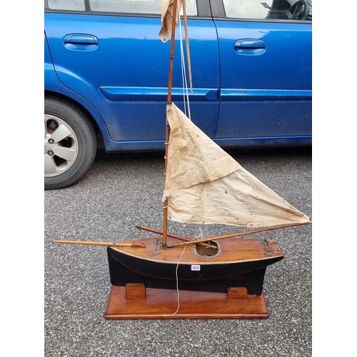 1830 - An old pond yacht, the hull 66cm long, on mahogany stand. 