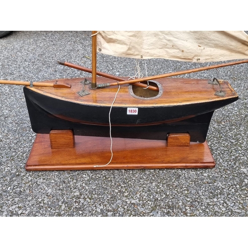 1830 - An old pond yacht, the hull 66cm long, on mahogany stand. 