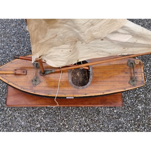 1830 - An old pond yacht, the hull 66cm long, on mahogany stand. 