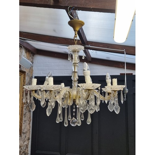 1714A - A modern eight branch chandelier, having glass drops, approximately 70cm diameter.