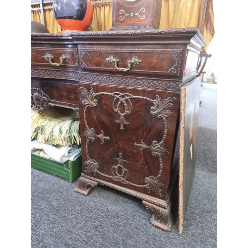 1075 - A large and impressive early 20th century carved mahogany sideboard, with original brass gallery bac... 