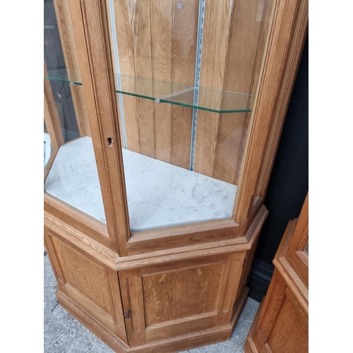 1002 - A large pair of modern pale oak display cabinets, 242cm high x 96cm wide x 48cm deep.... 