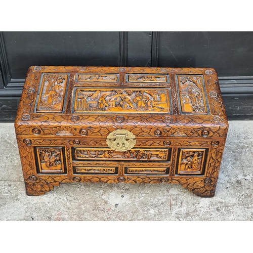 1003 - A small Chinese carved camphor wood coffer, 70.5cm wide.