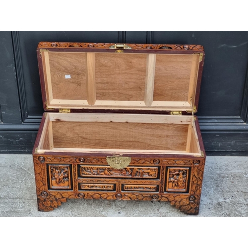 1003 - A small Chinese carved camphor wood coffer, 70.5cm wide.