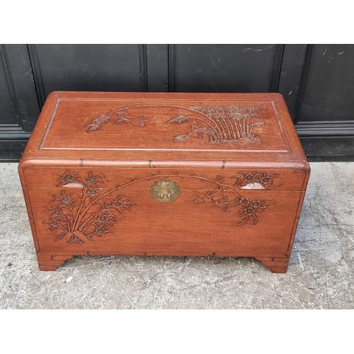 1007 - A Chinese carved camphor wood coffer, 94cm wide.