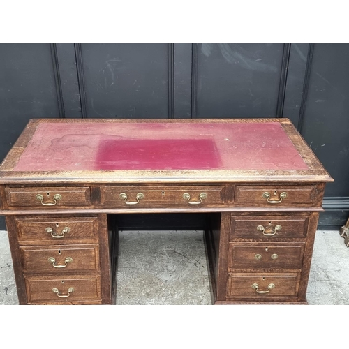 1019 - An old oak pedestal desk, 137cm wide.