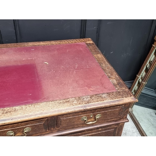 1019 - An old oak pedestal desk, 137cm wide.