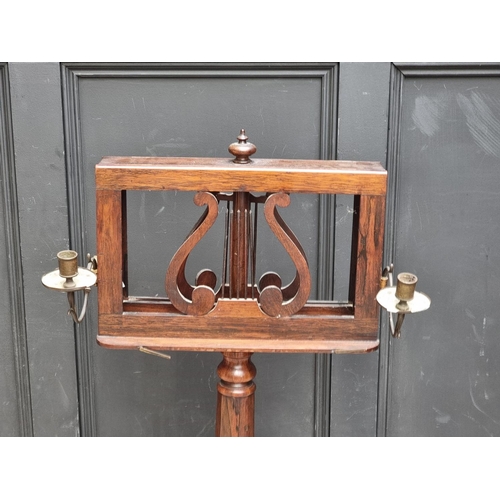 1028 - A William IV rosewood duet stand, with brass candle branches, 44.5cm wide, (s.d.).... 