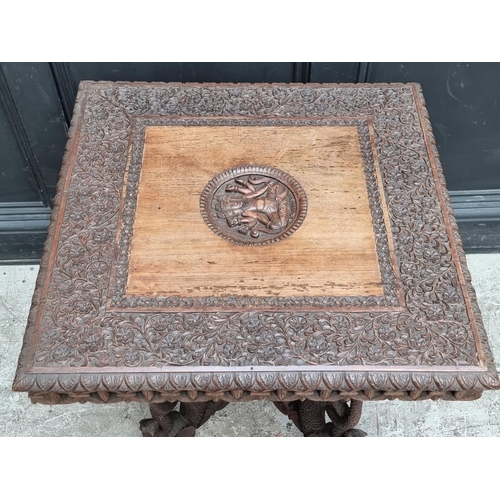 1031 - A late 19th century Anglo-Indian carved hardwood occasional table, 59cm wide.