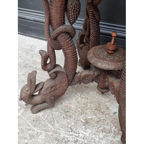 1031 - A late 19th century Anglo-Indian carved hardwood occasional table, 59cm wide.