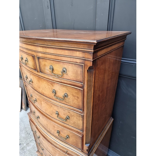 1035 - A small reproduction walnut and crossbanded chest on chest, 73.5cm wide.