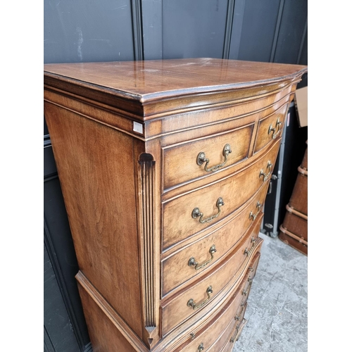 1035 - A small reproduction walnut and crossbanded chest on chest, 73.5cm wide.