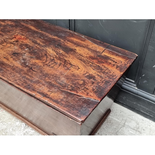 1038 - An early 19th century elm dough bin and cover, 114cm wide.