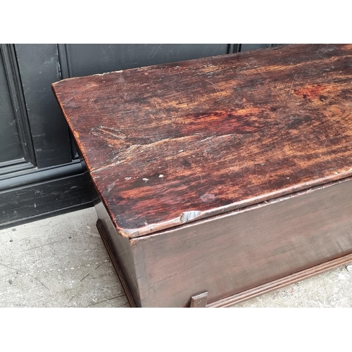 1038 - An early 19th century elm dough bin and cover, 114cm wide.