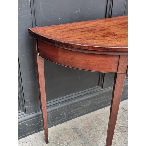 1039 - A George III mahogany and line inlaid demi-lune tea table, with double gateleg action, 95.5cm wide.... 