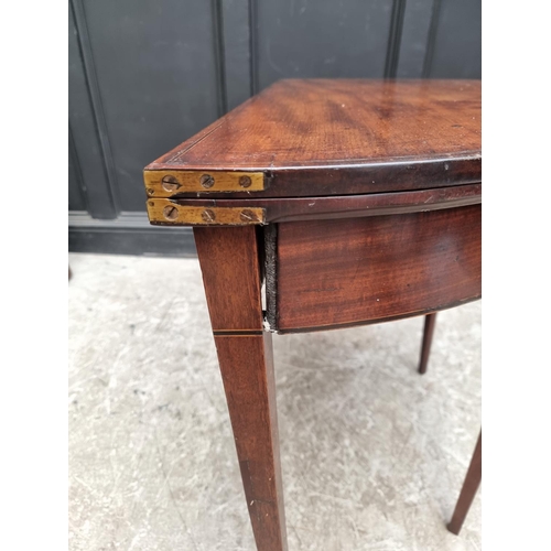 1039 - A George III mahogany and line inlaid demi-lune tea table, with double gateleg action, 95.5cm wide.... 