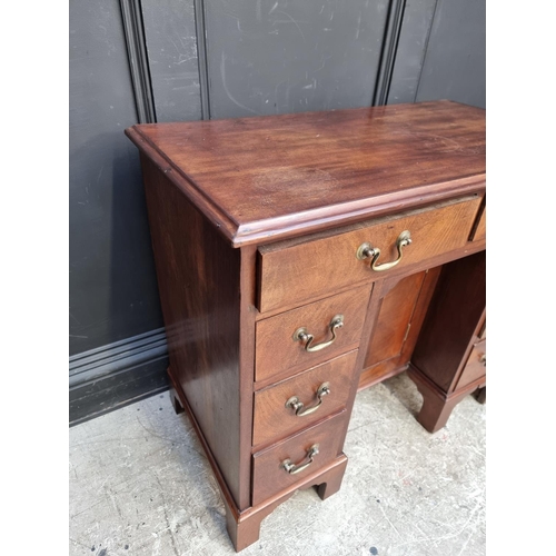 1042 - A mahogany kneehole chest, 84cm wide.