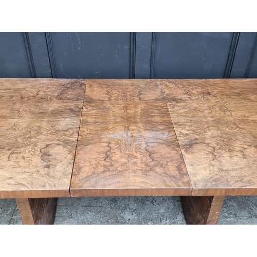 1049 - An Art Deco figured walnut extending dining table and four matching chairs, the table 212cm ext... 