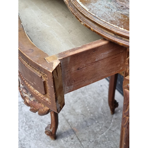 1050 - A Louis XV style giltwood writing table, 77cm wide, (lacking inset surface).