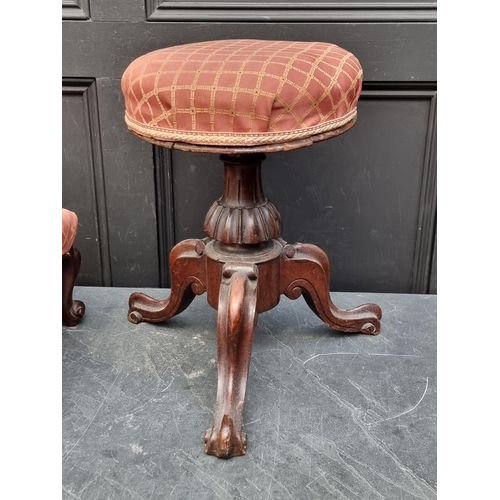 1051 - A Victorian walnut adjustable piano stool, (mechanism a.f.); together with another Victorian wa... 