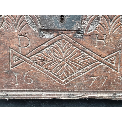 1057 - A small Charles II carved oak coffer, initialled 'P H' and dated 1677, 63.5cm wide.... 