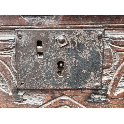 1057 - A small Charles II carved oak coffer, initialled 'P H' and dated 1677, 63.5cm wide.... 