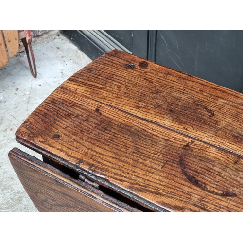 1058 - A late 17th century oak gateleg table, with lateral frieze drawer, 88cm wide.