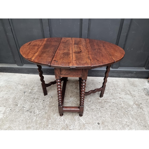 1058 - A late 17th century oak gateleg table, with lateral frieze drawer, 88cm wide.