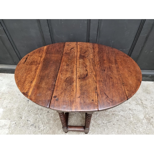 1058 - A late 17th century oak gateleg table, with lateral frieze drawer, 88cm wide.